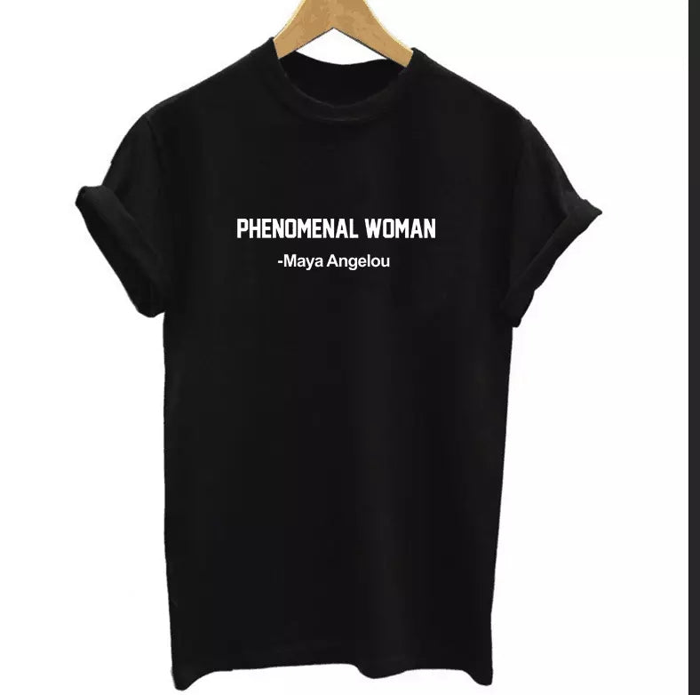 A black t-shirt with the phrase 'PHENOMENAL WOMAN -Maya Angelou' printed in white on the front.